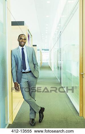 Stock Photography - Businessman smiling in office. Fotosearch