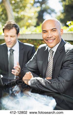 Businessman smiling outdoors View Large Photo Image Stock Image - Businessman smiling outdoors. Fotosearch