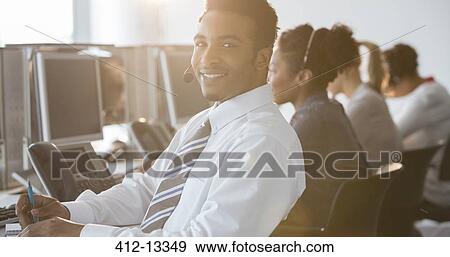 Businessman with headset smiling in office View Large Photo Image Stock Photo - Businessman with headset smiling in office. Fotosearch