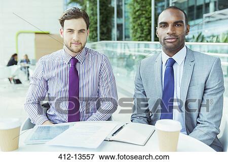 Businessmen smiling in office View Large Photo Image Stock Photo - Businessmen smiling in office. Fotosearch