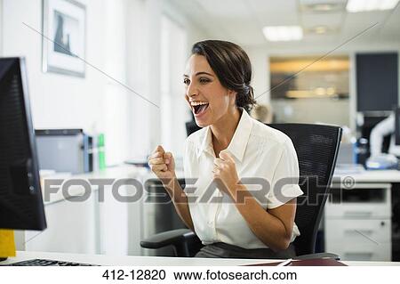 Businesswoman cheering in office View Large Photo Image Stock Image - Businesswoman cheering in office. Fotosearch