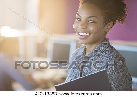 Businesswoman smiling in office View Large Photo Image Stock Image - Businesswoman smiling in office. Fotosearch