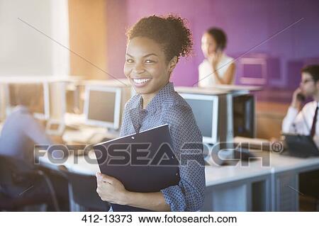 Businesswoman smiling in office View Large Photo Image Stock Image - Businesswoman smiling in office. Fotosearch
