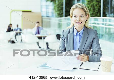 Stock Photography - Businesswoman smiling in office. Fotosearch