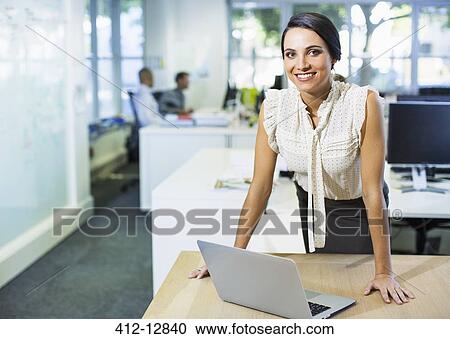 Businesswoman using laptop in office View Large Photo Image Stock Image - Businesswoman using laptop in office. Fotosearch