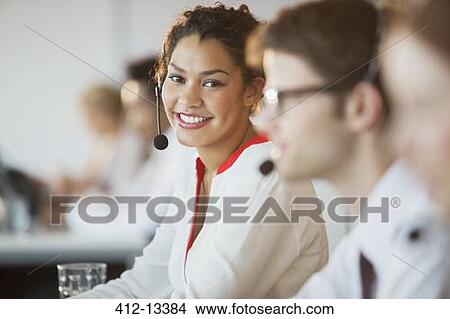 Businesswoman wearing headset in office View Large Photo Image Picture - Businesswoman wearing headset in office. Fotosearch