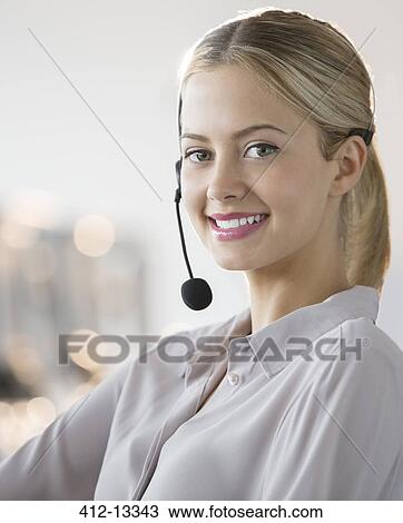 Businesswoman wearing headset in office View Large Photo Image Stock Image - Businesswoman wearing headset in office. Fotosearch