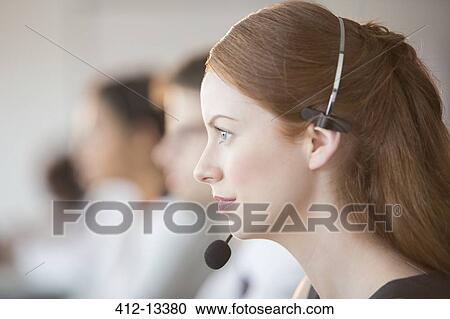 Businesswoman wearing headset in office View Large Photo Image Stock Image - Businesswoman wearing headset in office. Fotosearch