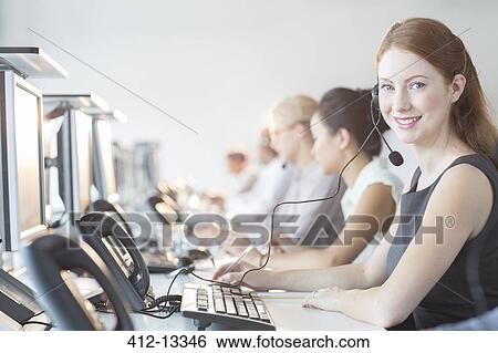 Businesswoman wearing headset in office View Large Photo Image Stock Photograph - Businesswoman wearing headset in office. Fotosearch