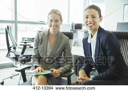 Businesswomen smiling in office View Large Photo Image Picture - Businesswomen smiling in office. Fotosearch