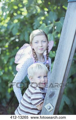 Stock Photography - Children climbing ladder outdoors. Fotosearch