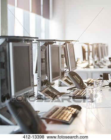 Stock Photo - Computers and telephones at desk in office. Fotosearch