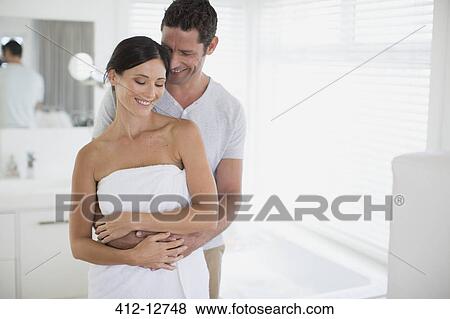 Couple hugging in bathroom View Large Photo Image Stock Photo - Couple hugging in bathroom. Fotosearch