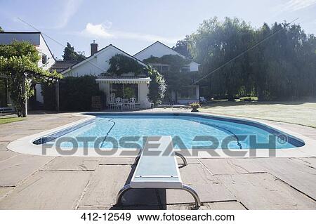 Diving board at the edge of swimming pool View Large Photo Image Stock Photo - Diving board at the edge of swimming pool. Fotosearch