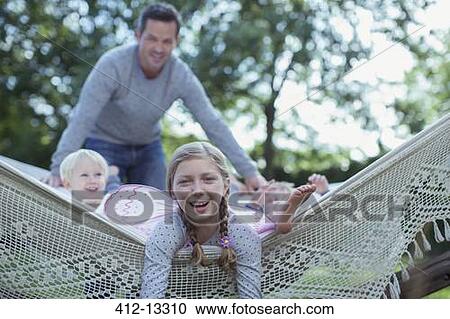 Father and children laying in hammock outdoors View Large Photo Image Stock Image - Father and children laying in hammock outdoors. Fotosearch