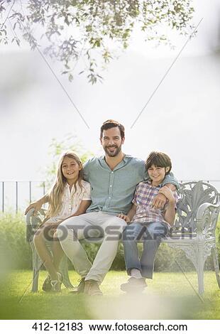 Father and children relaxing on park bench View Large Photo Image Stock Image - Father and children relaxing on park bench. Fotosearch