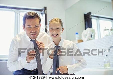 Father and daughter adjusting ties in bathroom View Large Photo Image Picture - Father and daughter adjusting ties in bathroom. Fotosearch