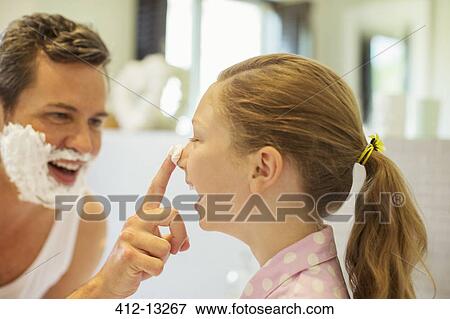 Stock Photo - Father and daughter playing with shaving cream in bathroom. Fotosearch
