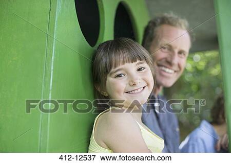 Father and daughter smiling in treehouse View Large Photo Image Stock Photo - Father and daughter smiling in treehouse. Fotosearch