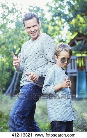 Father and son gesturing outdoors View Large Photo Image Stock Image - Father and son gesturing outdoors. Fotosearch