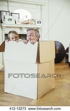 Father and son playing in cardboard box View Large Photo Image Stock Image - Father and son playing in cardboard box. Fotosearch