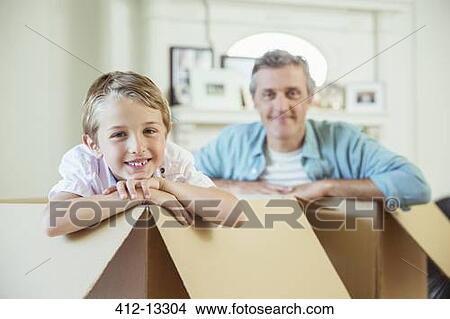 Father and son playing in cardboard boxes View Large Photo Image Picture - Father and son playing in cardboard boxes. Fotosearch