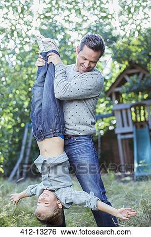 Stock Photograph - Father and son playing outdoors. Fotosearch