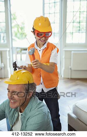 Stock Image - Father and son playing with construction toys. Fotosearch