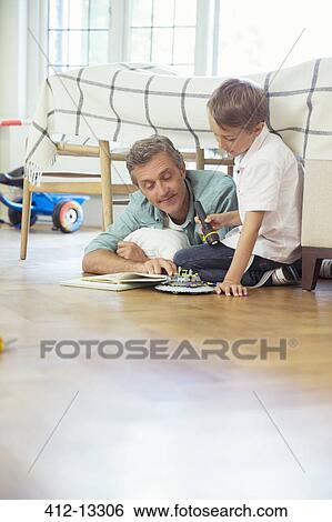 Father and son reading in bedroom View Large Photo Image Stock Photograph - Father and son reading in bedroom. Fotosearch