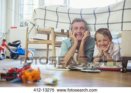 Stock Photography - Father and son reading together. Fotosearch