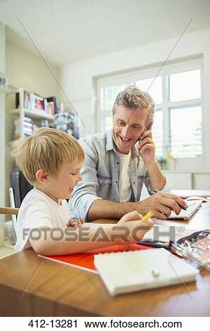 Father and son working in home office View Large Photo Image Stock Image - Father and son working in home office. Fotosearch