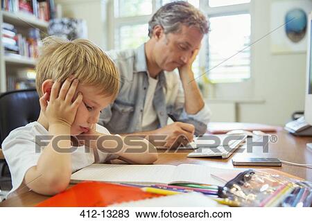 Father and son working in home office View Large Photo Image Stock Image - Father and son working in home office. Fotosearch