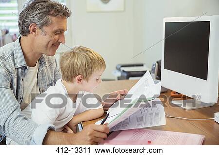 Father and son working in home office View Large Photo Image Stock Image - Father and son working in home office. Fotosearch
