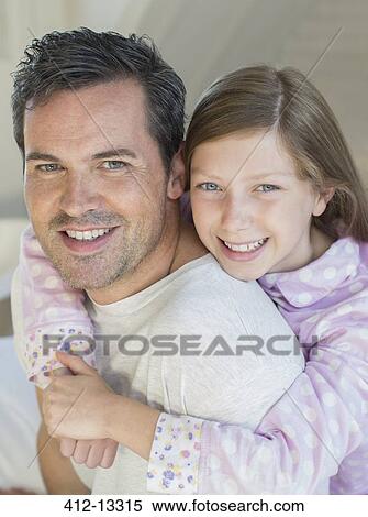 Stock Photography - Father carrying daughter piggyback. Fotosearch
