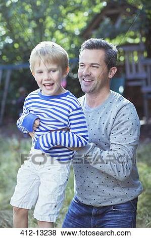 Father carrying son outdoors View Large Photo Image Stock Photo - Father carrying son outdoors. Fotosearch