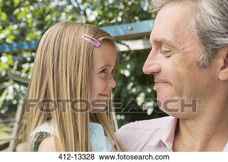 Father holding daughter outdoors View Large Photo Image Stock Photo - Father holding daughter outdoors. Fotosearch
