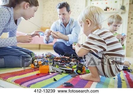 Stock Photo - Father playing with children. Fotosearch
