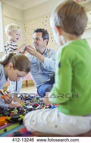 Stock Photograph - Father playing with children. Fotosearch