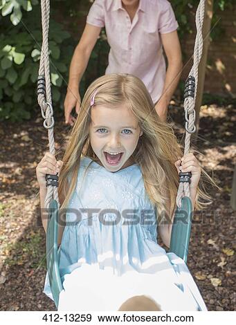 Father pushing daughter in swing View Large Photo Image Stock Photo - Father pushing daughter in swing. Fotosearch