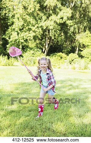 Girl playing with butterfly net in backyard View Large Photo Image Stock Photography - Girl playing with butterfly net in backyard. Fotosearch