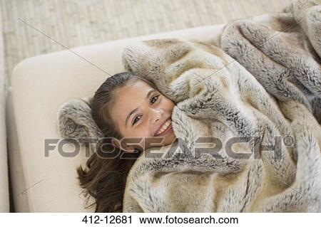 Girl relaxing under fur blanket View Large Photo Image Stock Image - Girl relaxing under fur blanket. Fotosearch