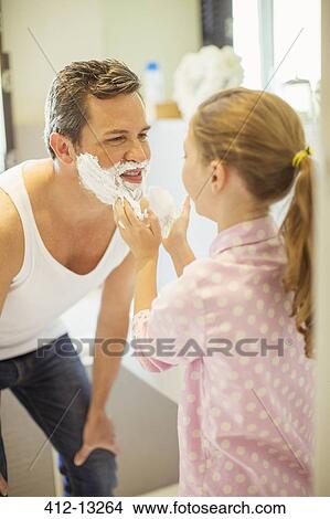 Picture - Girl rubbing shaving cream on father's face. Fotosearch
