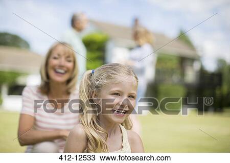 Grandmother and granddaughter smiling outdoors View Large Photo Image Stock Image - Grandmother and granddaughter smiling outdoors. Fotosearch
