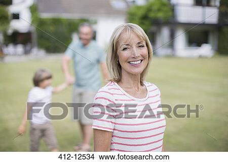 Grandparents and grandson in backyard View Large Photo Image Picture - Grandparents and grandson in backyard. Fotosearch