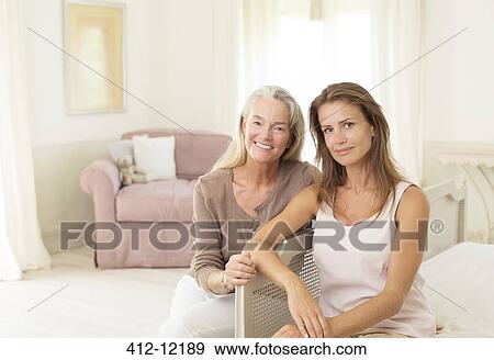 Mother and daughter smiling in bedroom View Large Photo Image Stock Photo - Mother and daughter smiling in bedroom. Fotosearch