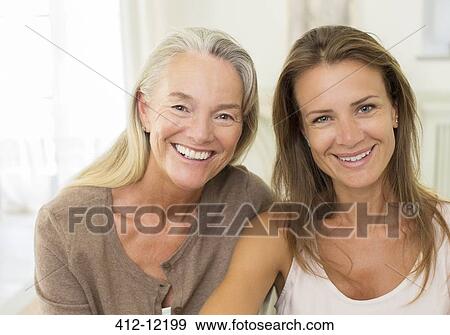 Stock Photo - Mother and daughter smiling indoors. Fotosearch