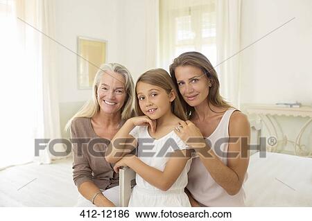 Stock Photograph - Multi-generation women in bedroom. Fotosearch