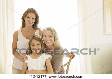 Stock Photo - Multi-generation women smiling at window. Fotosearch