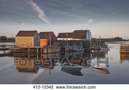 Rowboats and buildings on calm bay View Large Photo Image Stock Image - Rowboats and buildings on calm bay. Fotosearch