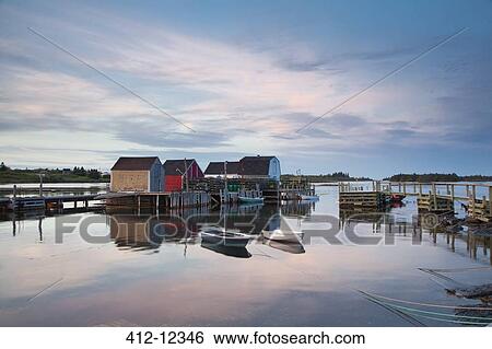 Rowboats and buildings on calm bay View Large Photo Image Stock Photograph - Rowboats and buildings on calm bay. Fotosearch